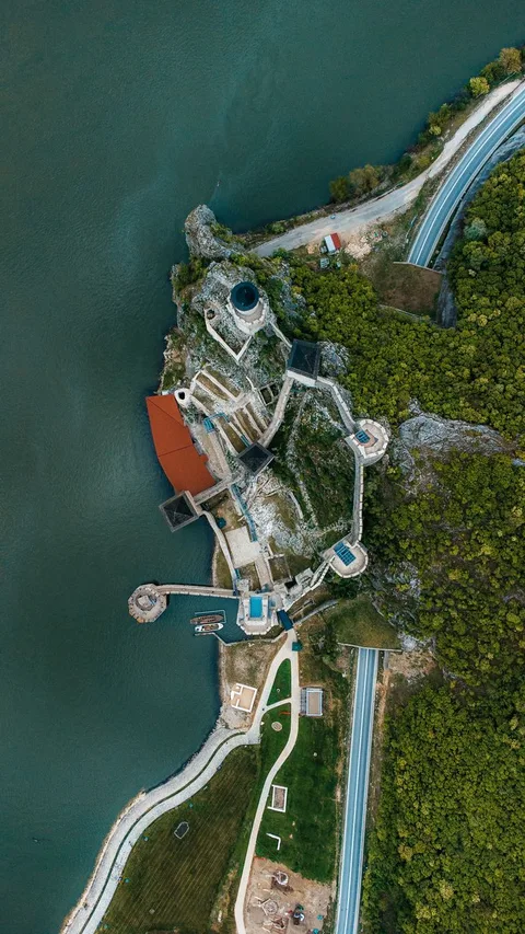 Aerial view of a medieval castle Parador on a rocky cliff above the water