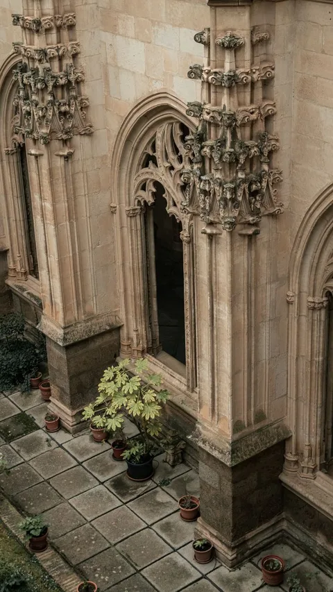 Gothic cloistered courtyard with pointed arches at a historic Parador monastery hotel in Spain
